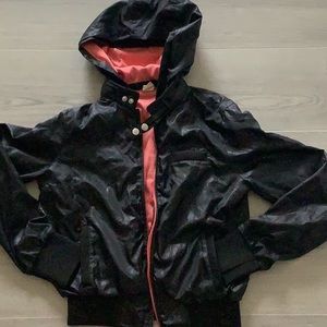 Women bomber style jacket with hoodie. Shell is 100% polyester. Lined.